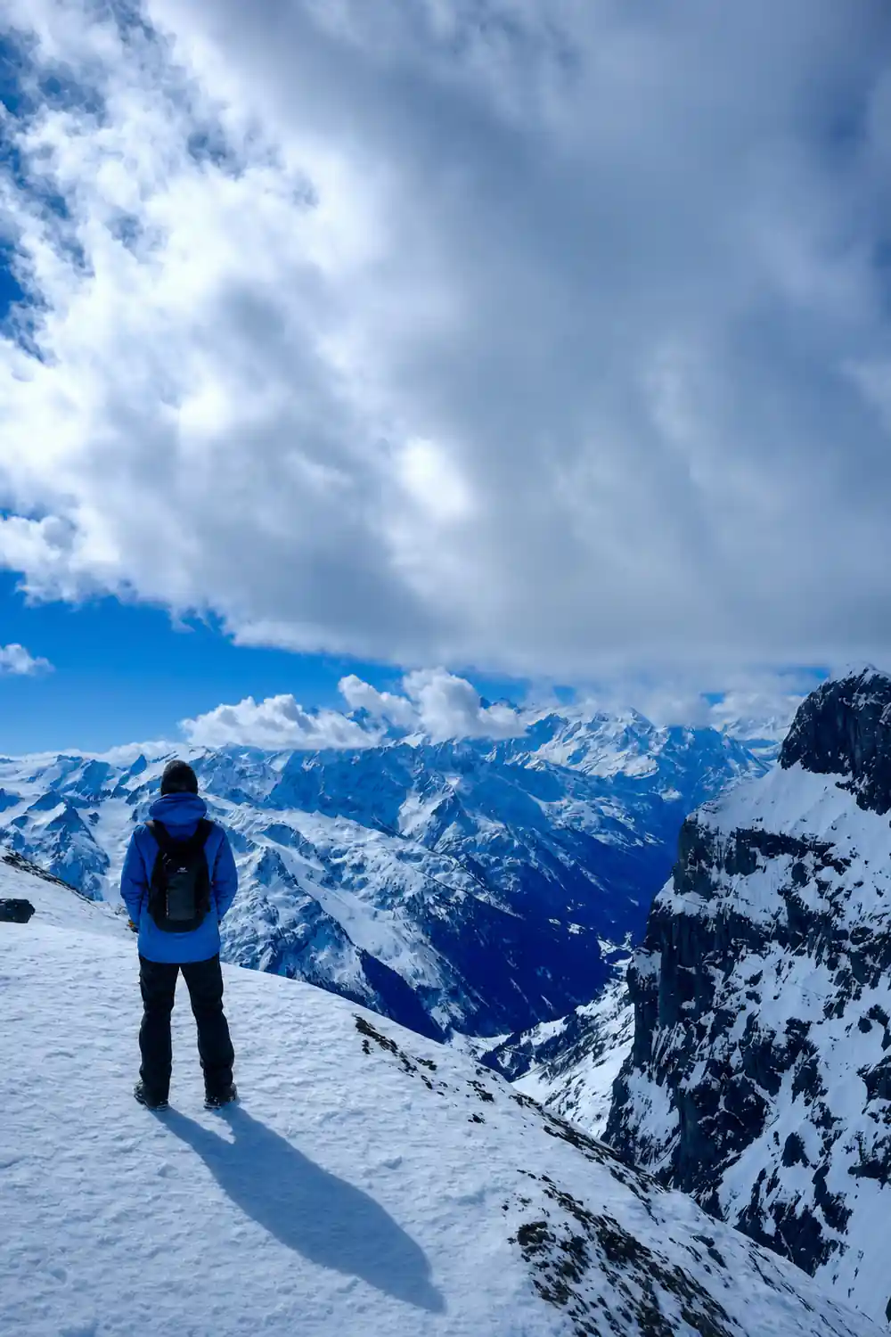 Cloud breaking over snow peaks seen from the summit
