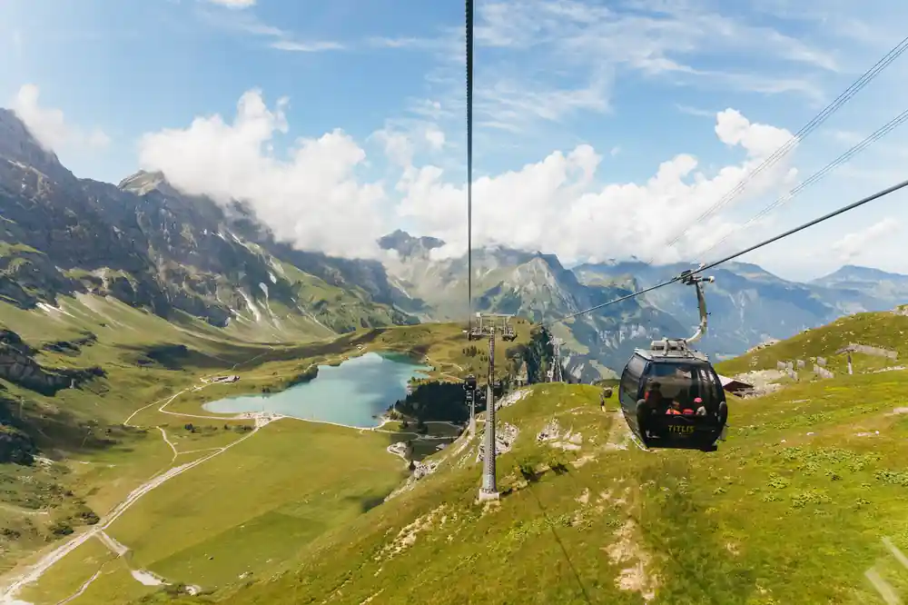 The gondola line above Trubsee lake and the green basin