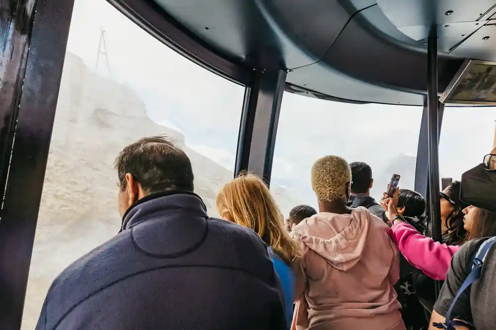 Inside the crowded cabin with the glacier through the window