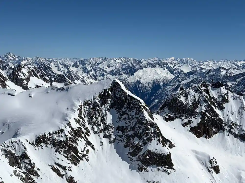 A line of snow peaks running to the horizon from the summit