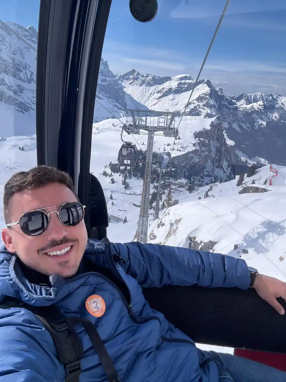 A passenger in the cabin with the snow slopes through the glass