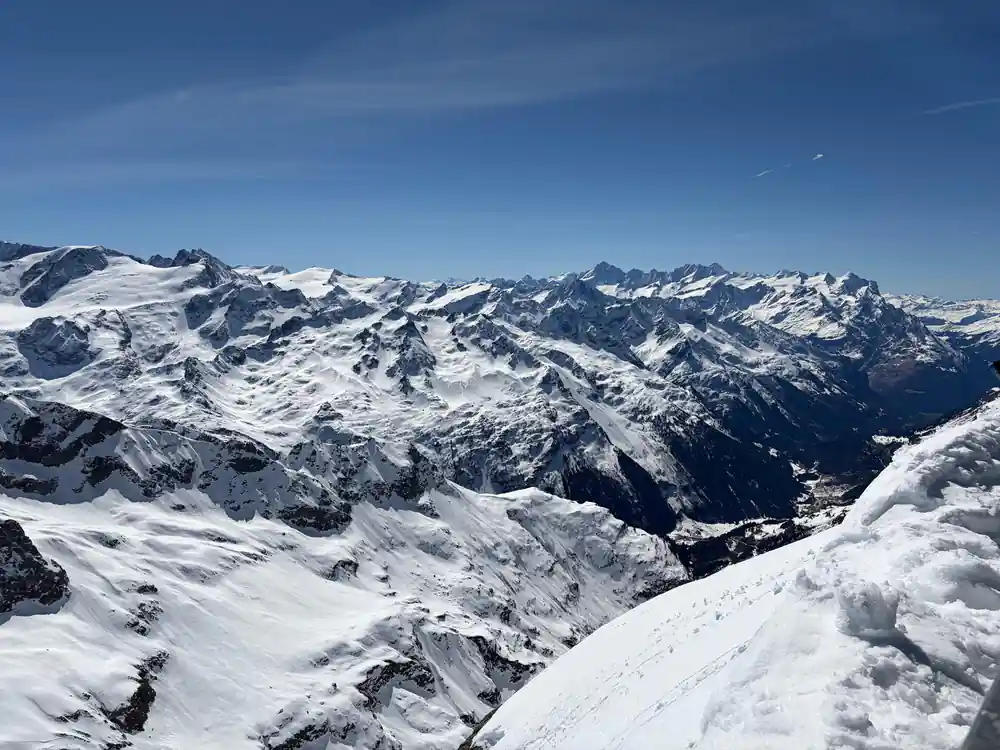Snow ridges and dark rock below the summit station