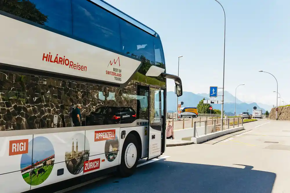 The tour coach parked at the kerb before departure
