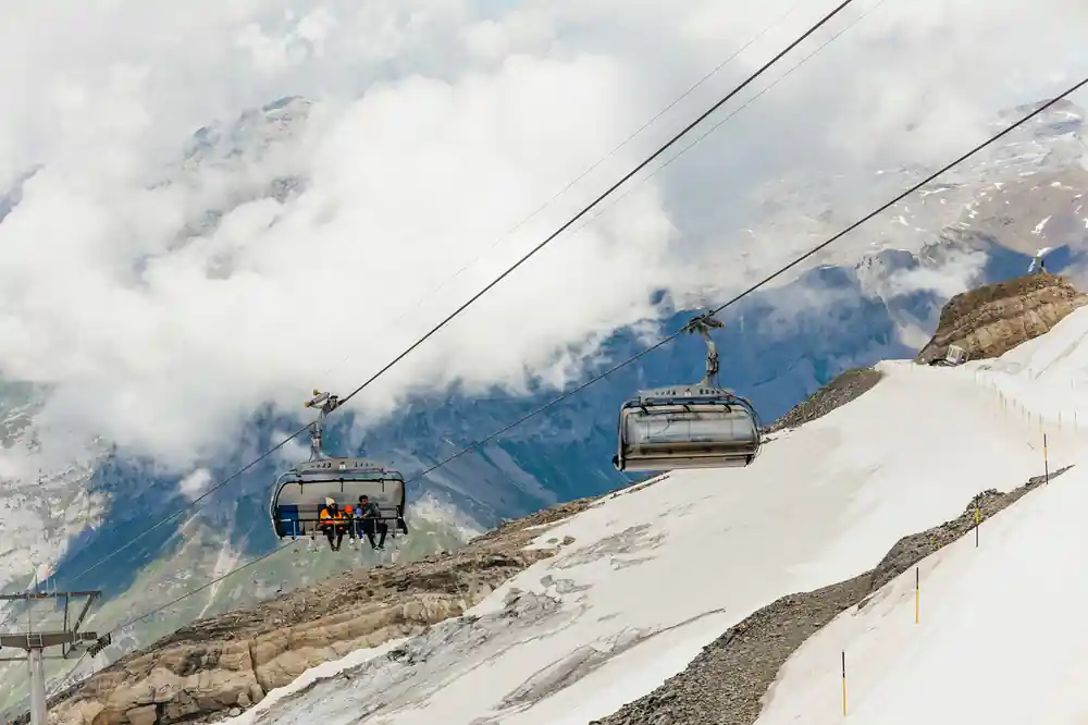 Two Ice Flyer chairs running above the snow under cloud