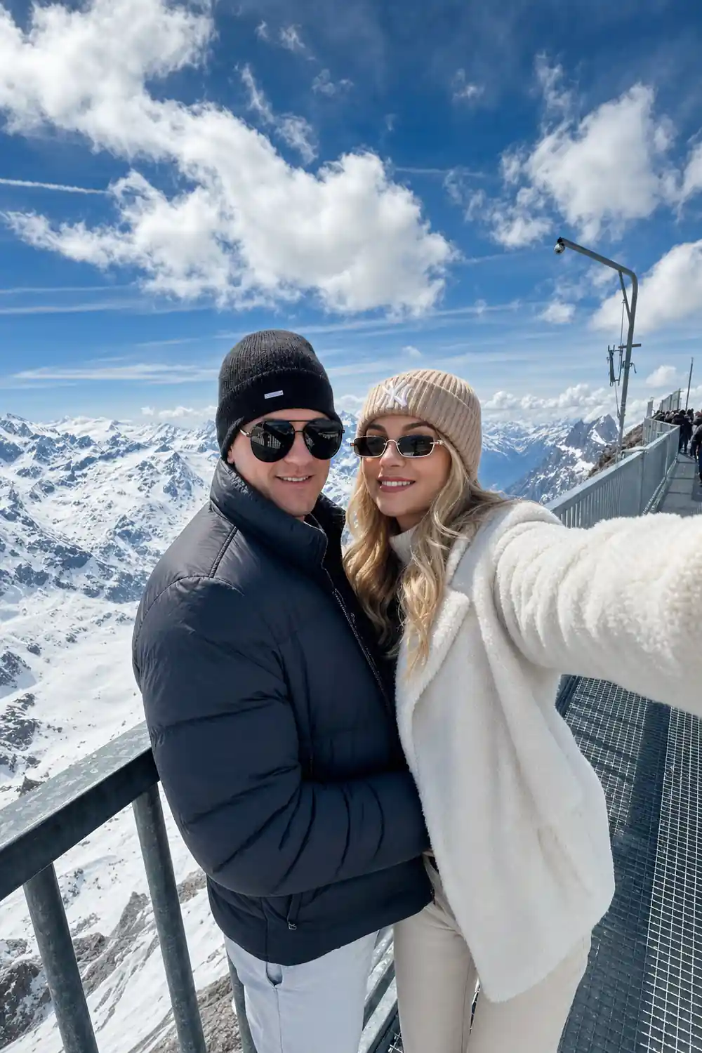 Two visitors taking a photograph together on the summit terrace