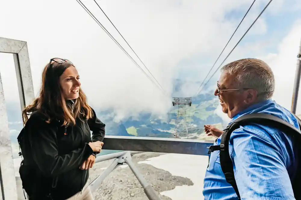 Two visitors talking on the terrace with cloud below them
