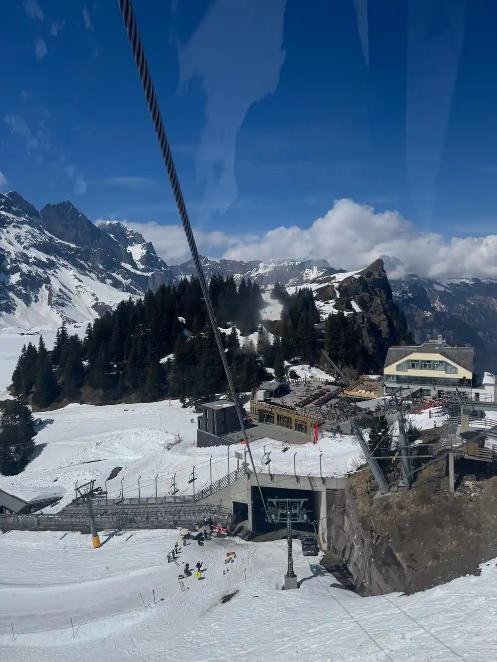 The upper station buildings on the snow with cables running down